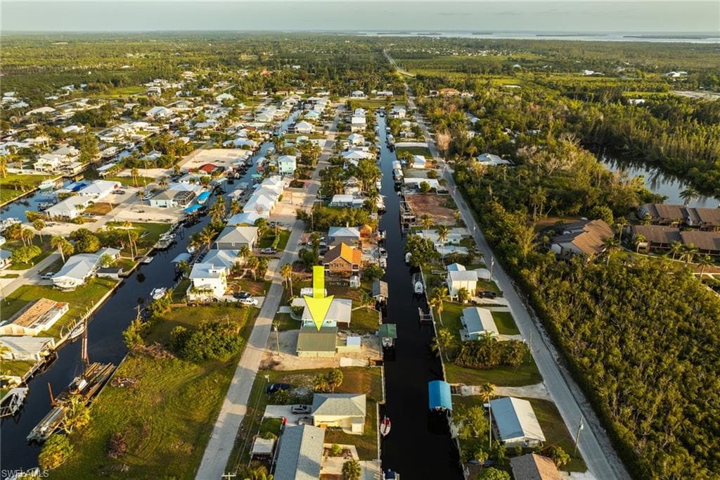 Aerial view of property's location with nearby suburban area and a nearby body of water
