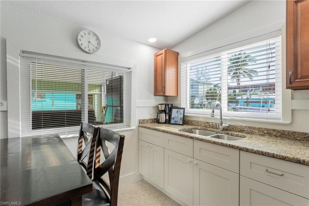 Kitchen featuring light stone countertops