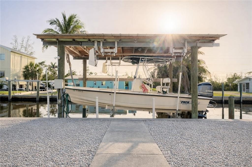 Dock area with boat lift and a water view