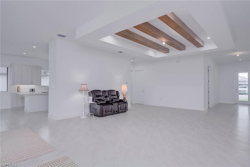 Sitting room with recessed lighting, beamed ceiling, and light tile patterned floors