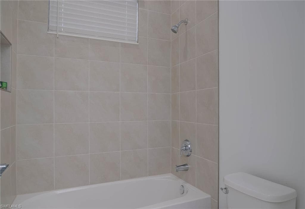 Bathroom with toilet and shower / tub combination