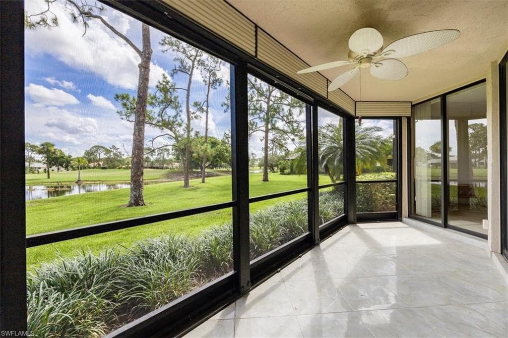 Unfurnished sunroom featuring a golf & water view