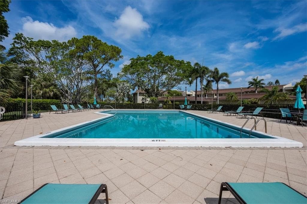 Community pool with a patio