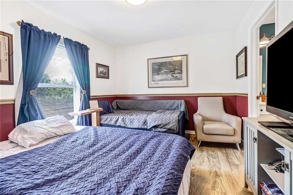 Bedroom with wood finished floors