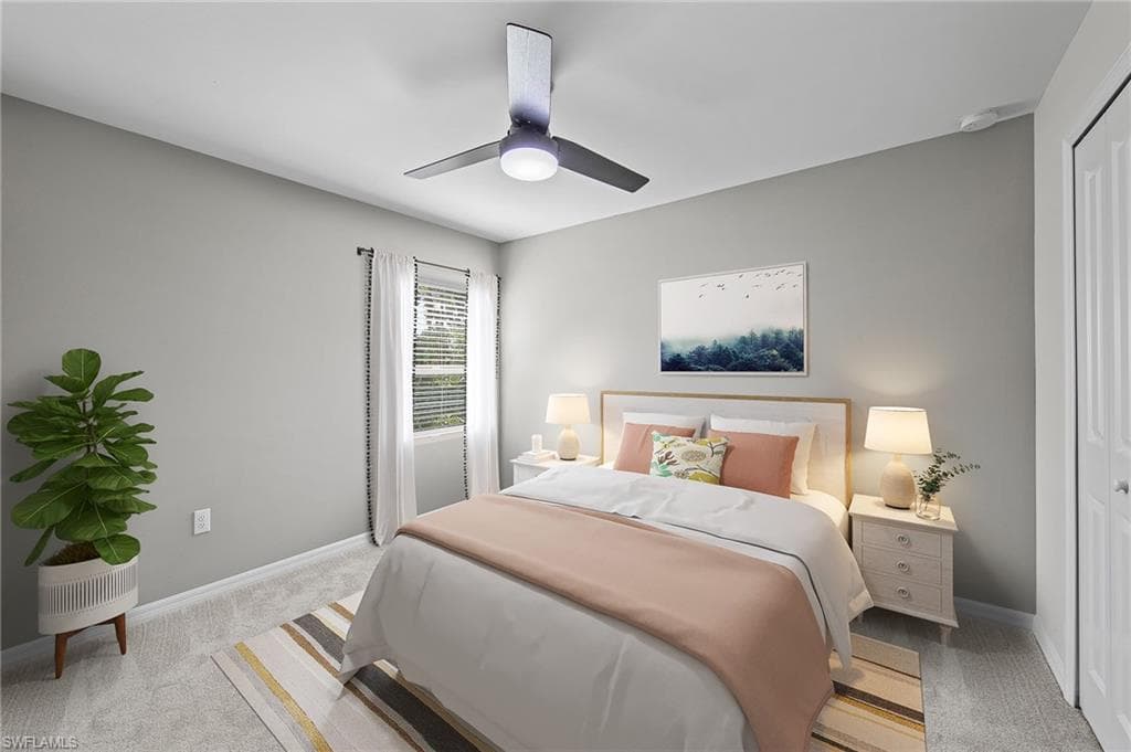 Bedroom with light carpet and a ceiling fan