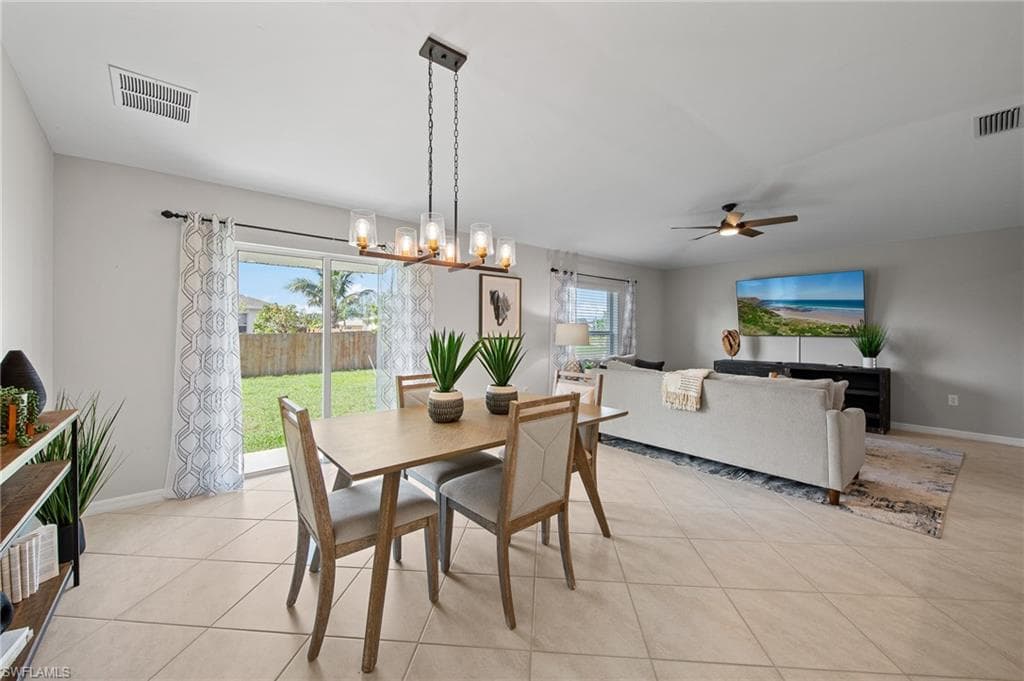 Dining room featuring ceiling fan and light tile patterned flooring