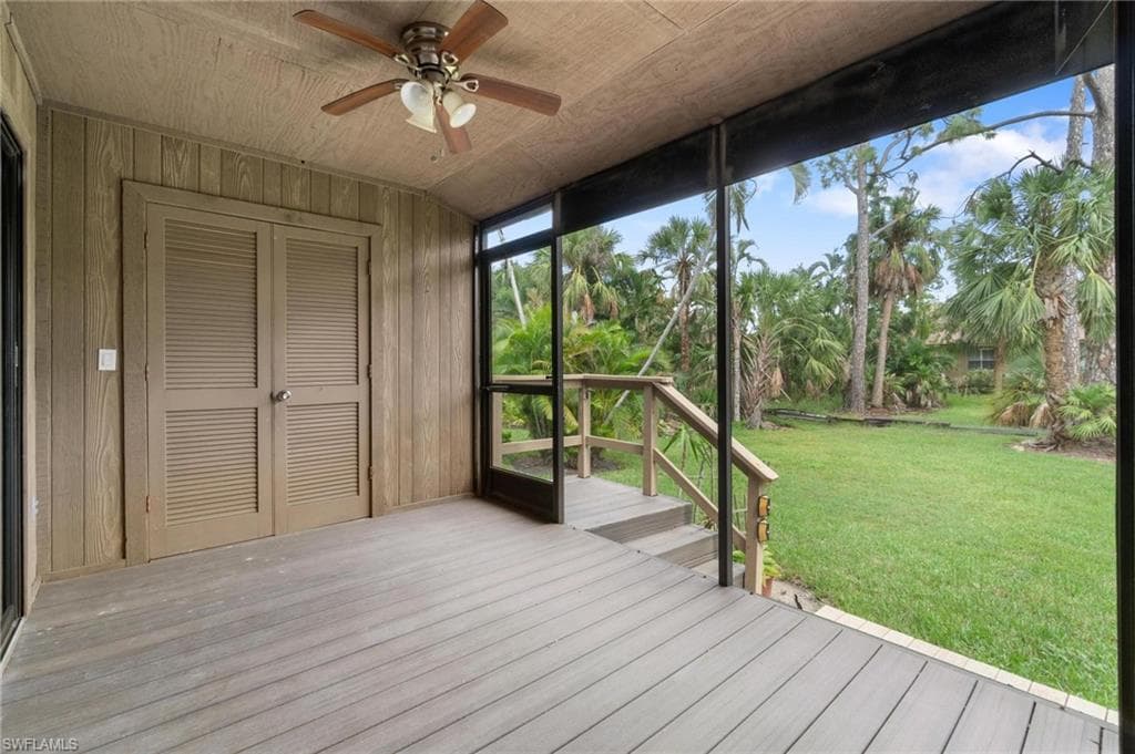 Unfurnished sunroom featuring a ceiling fan