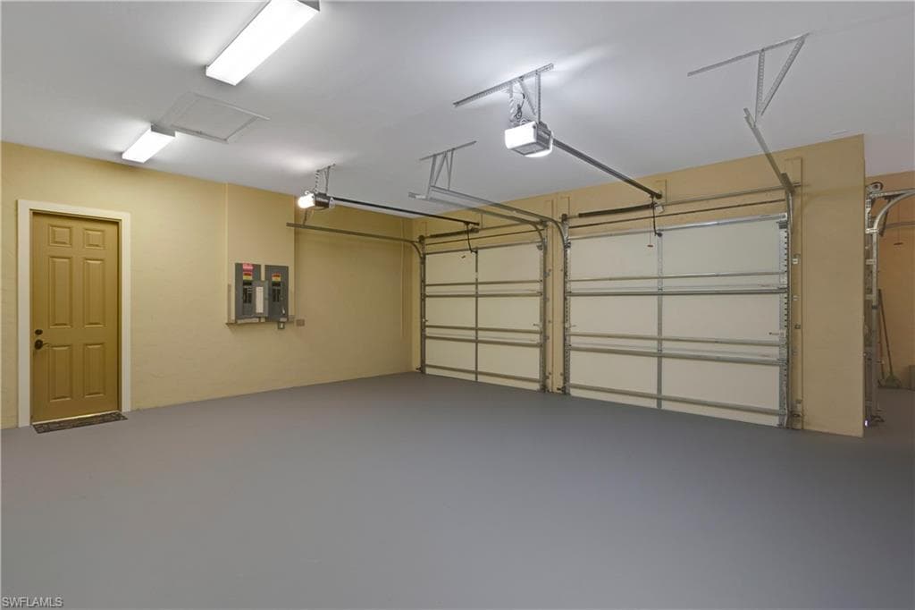 Garage with electric panel and a garage door opener
