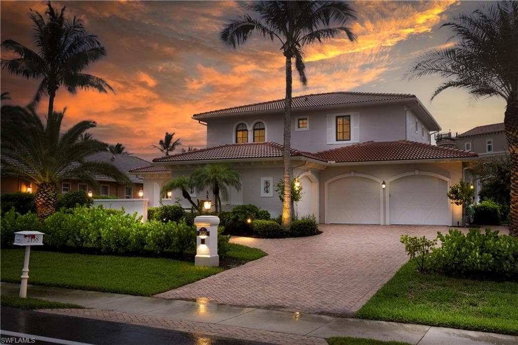Custom Sailboat Gulf--access home with southern exposure,, featuring pavered driveway, LED outdoor lighting, new interior and exterior paint (2025) stucco siding, a new tile roof (2023), and a front court yard.