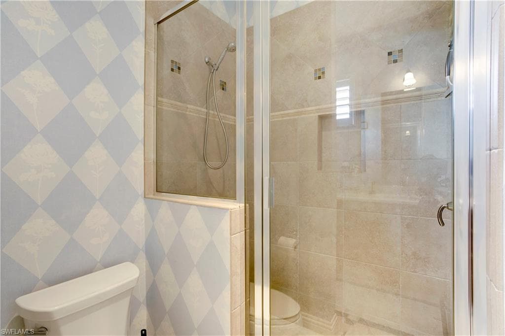 Full bathroom featuring a shower stall