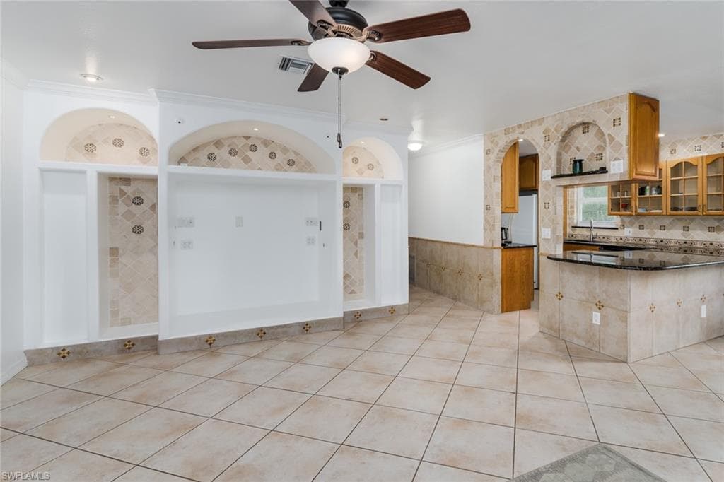 Living room featuring beautiful built-ins and tile flooring.