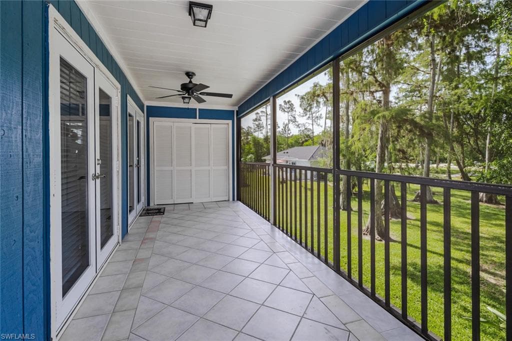 Unfurnished sunroom featuring ceiling fan