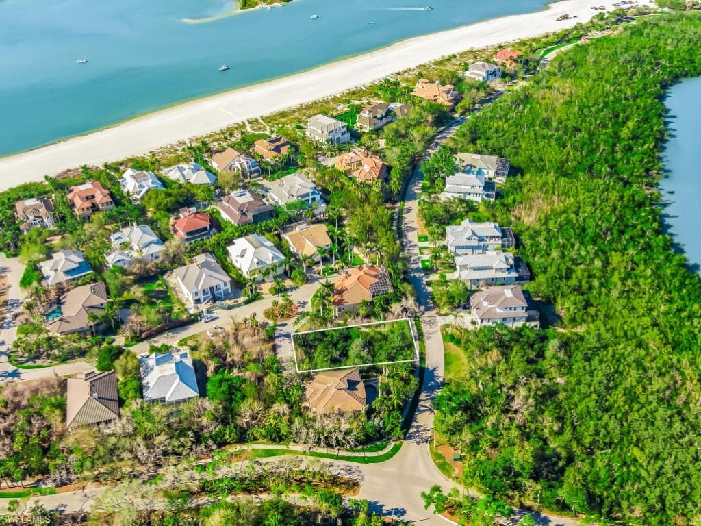Aerial perspective of suburban area with unending shoreline