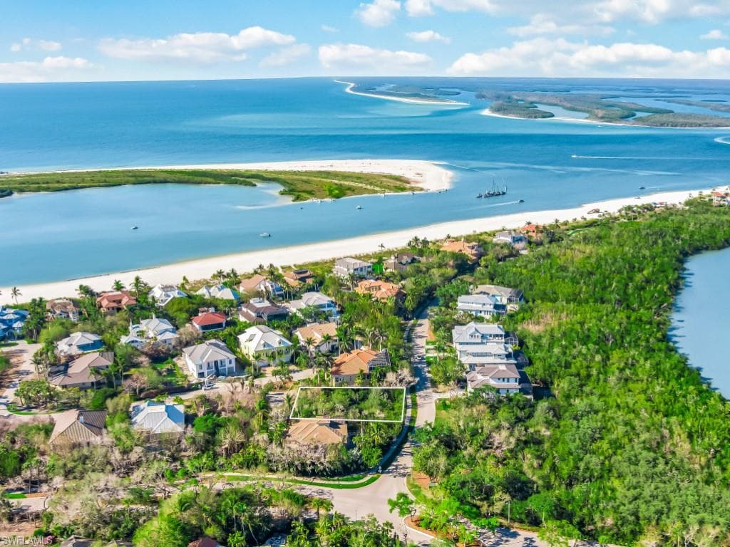 Aerial perspective of suburban area featuring a large body of water