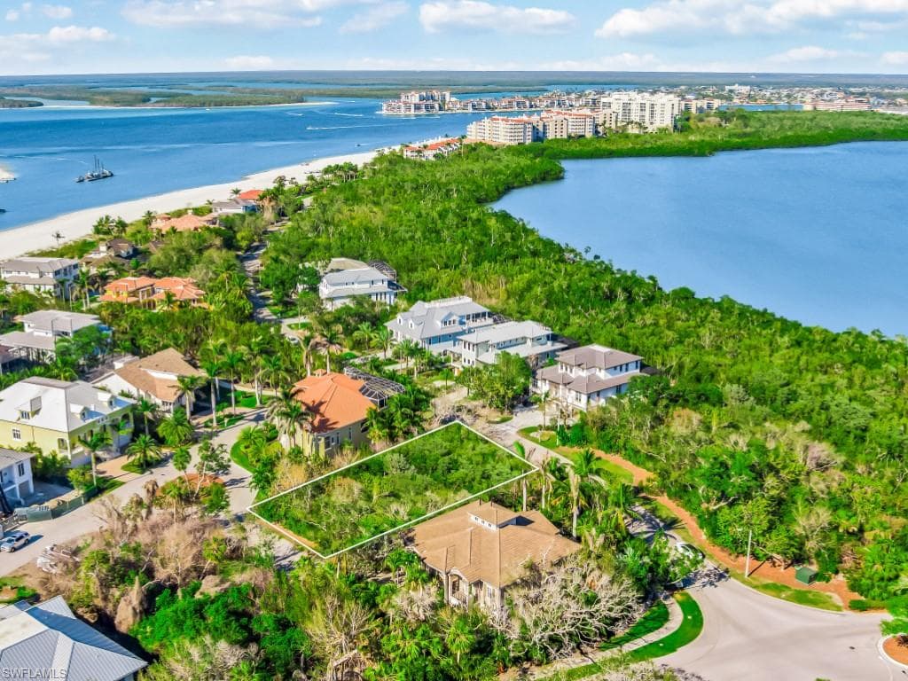 Aerial view of property's location with a nearby body of water and property boundaries highlighted