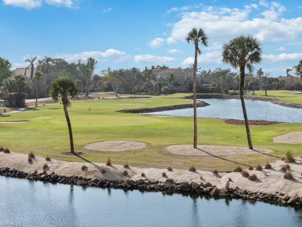 View of community featuring a water view, a yard, and view of golf course