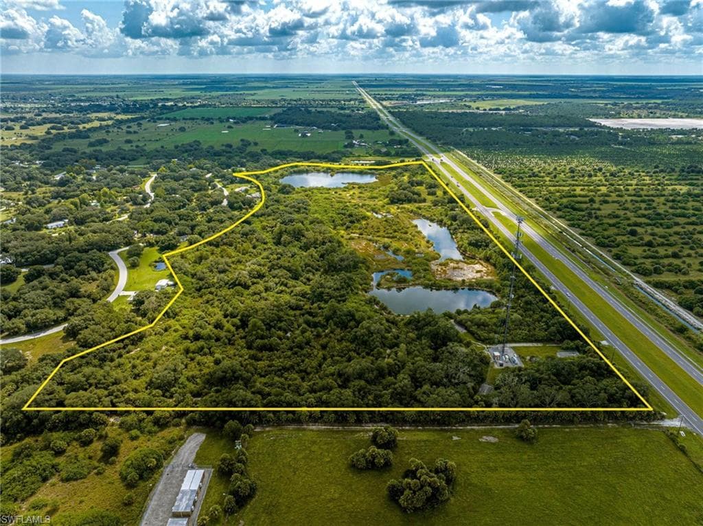 View of property location featuring property boundaries highlighted and a nearby body of water