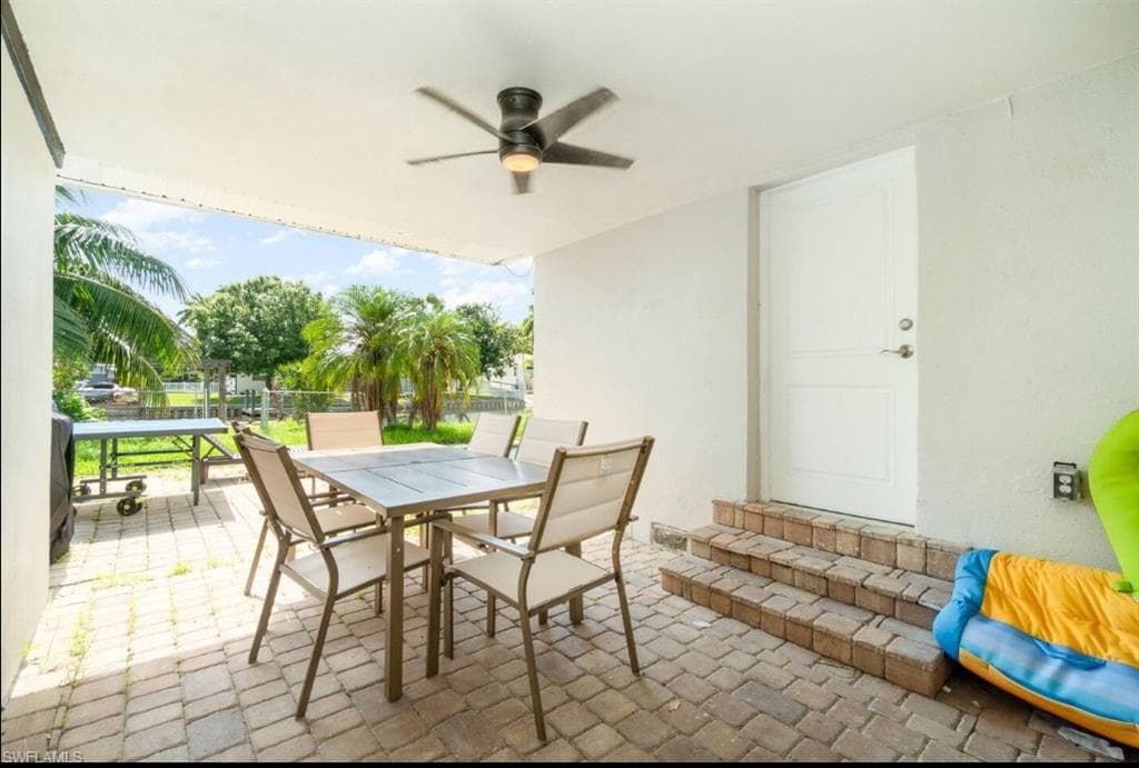 View of patio featuring outdoor dining space and ceiling fan