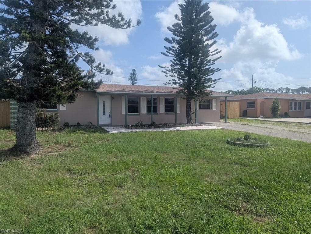 Single story home with driveway and stucco siding