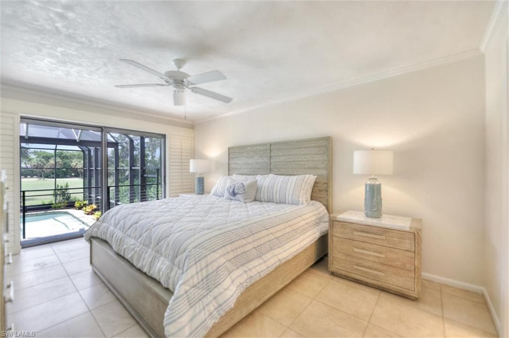 Bedroom with crown molding, a ceiling fan, light tile patterned flooring, and connected bathroom