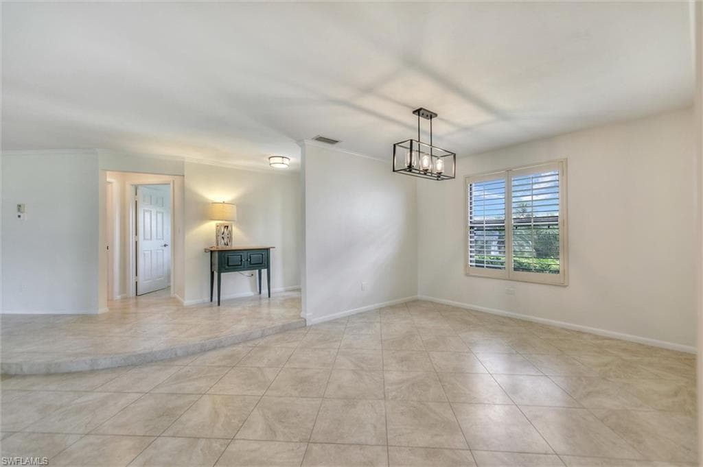 Unfurnished room featuring a ceiling fan and tile patterned flooring