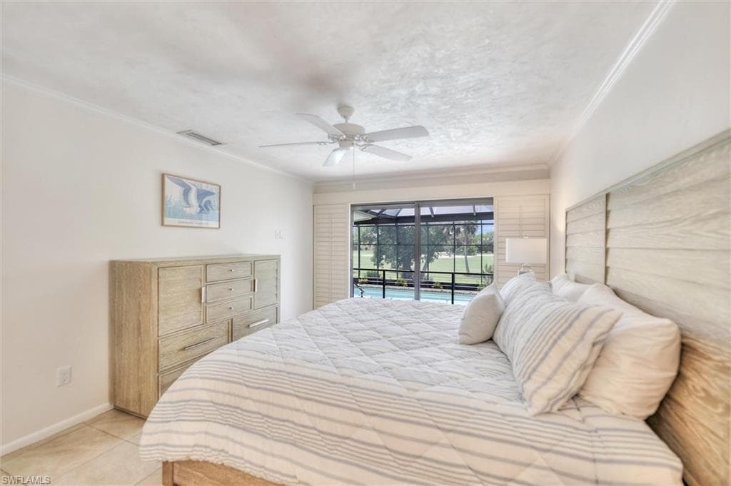 Bedroom with access to exterior, light tile patterned floors, crown molding, and ceiling fan
