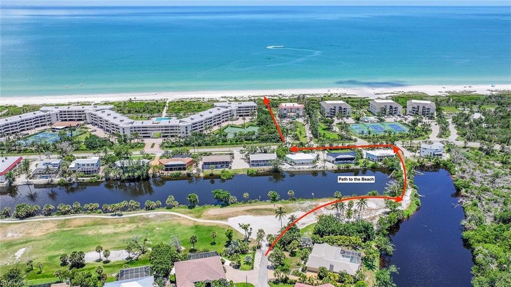 Aerial view of property's location featuring a large body of water