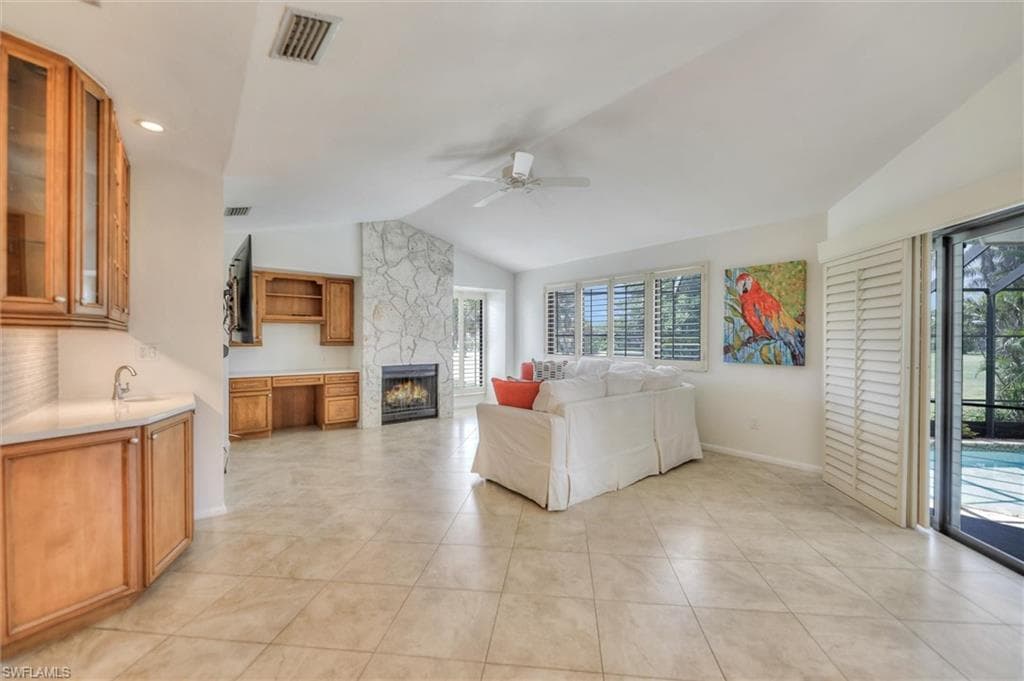Living area featuring light tile patterned floors and ornamental molding