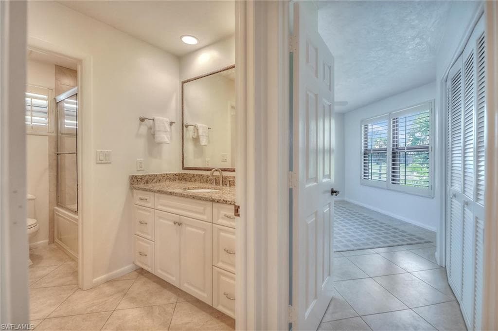 Dining room with a chandelier, light tile patterned floors, and crown molding