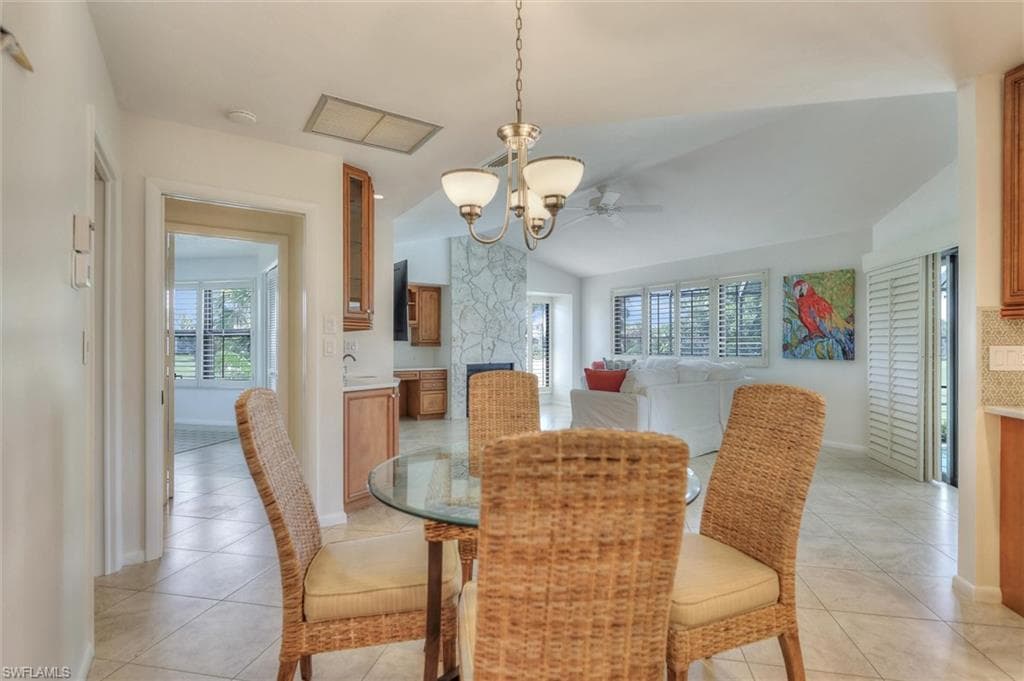 Dining space with recessed lighting, light tile patterned flooring, a chandelier, and ceiling fan