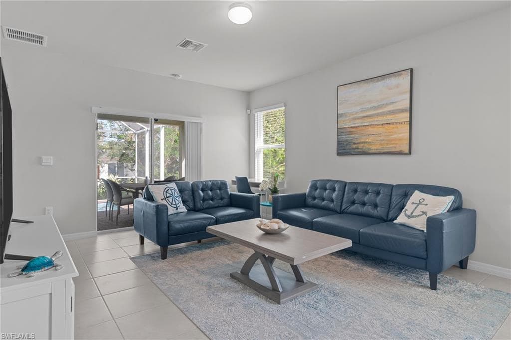 Living area featuring baseboards and light tile patterned floors