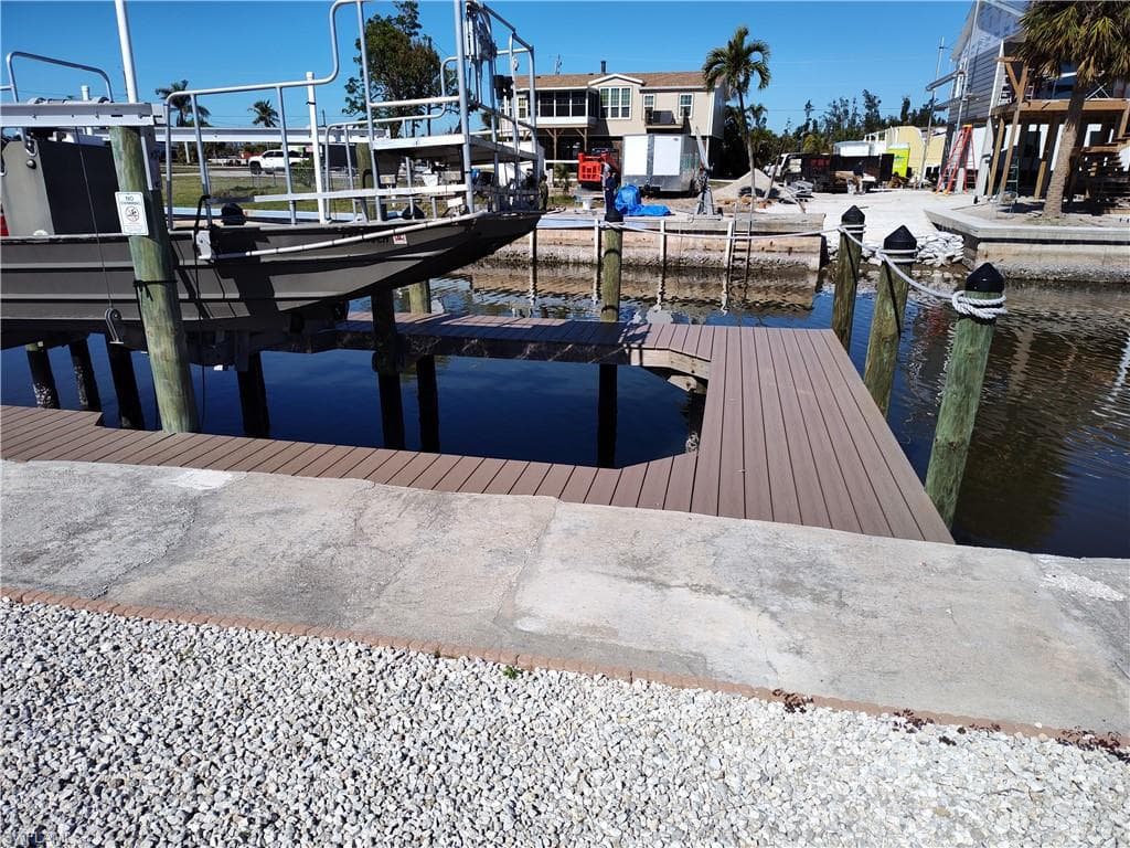Dock area with boat lift and a water view