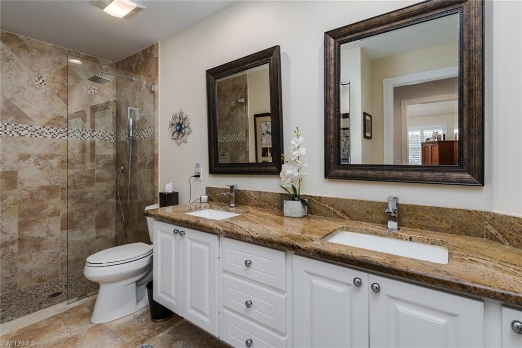 Full bath with a stall shower and double vanity