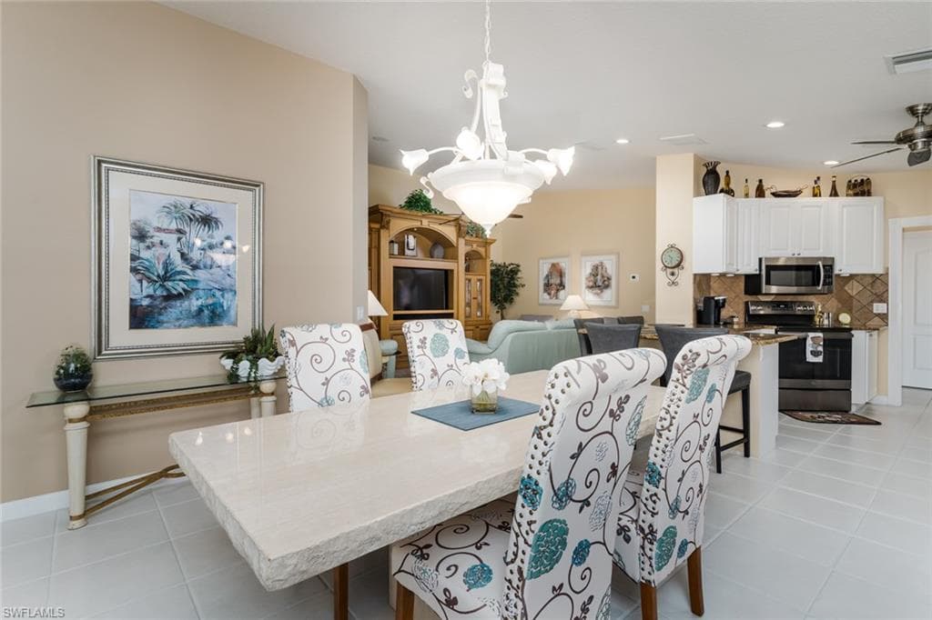 Dining space featuring light tile patterned floors, recessed lighting, and a ceiling fan