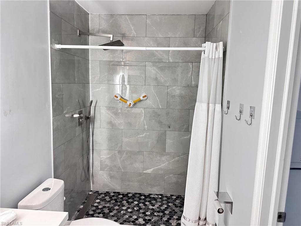Full bathroom with a shower stall and vanity