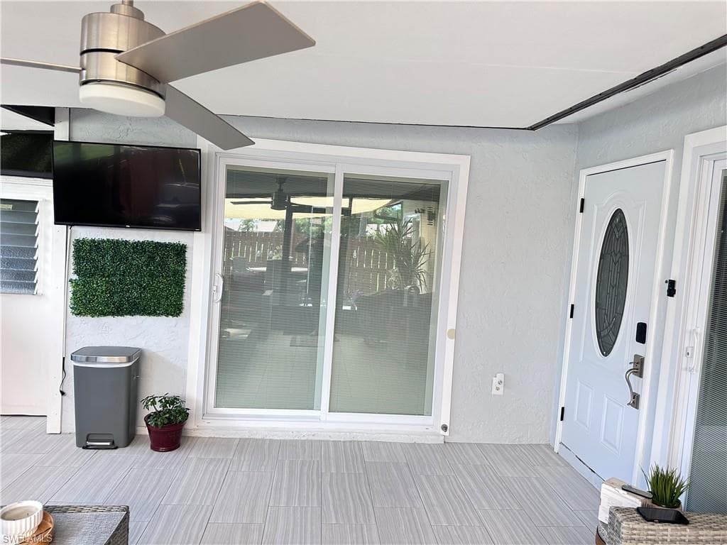 Doorway to property featuring stucco siding