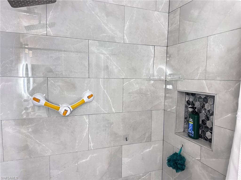Bathroom view of a tile shower