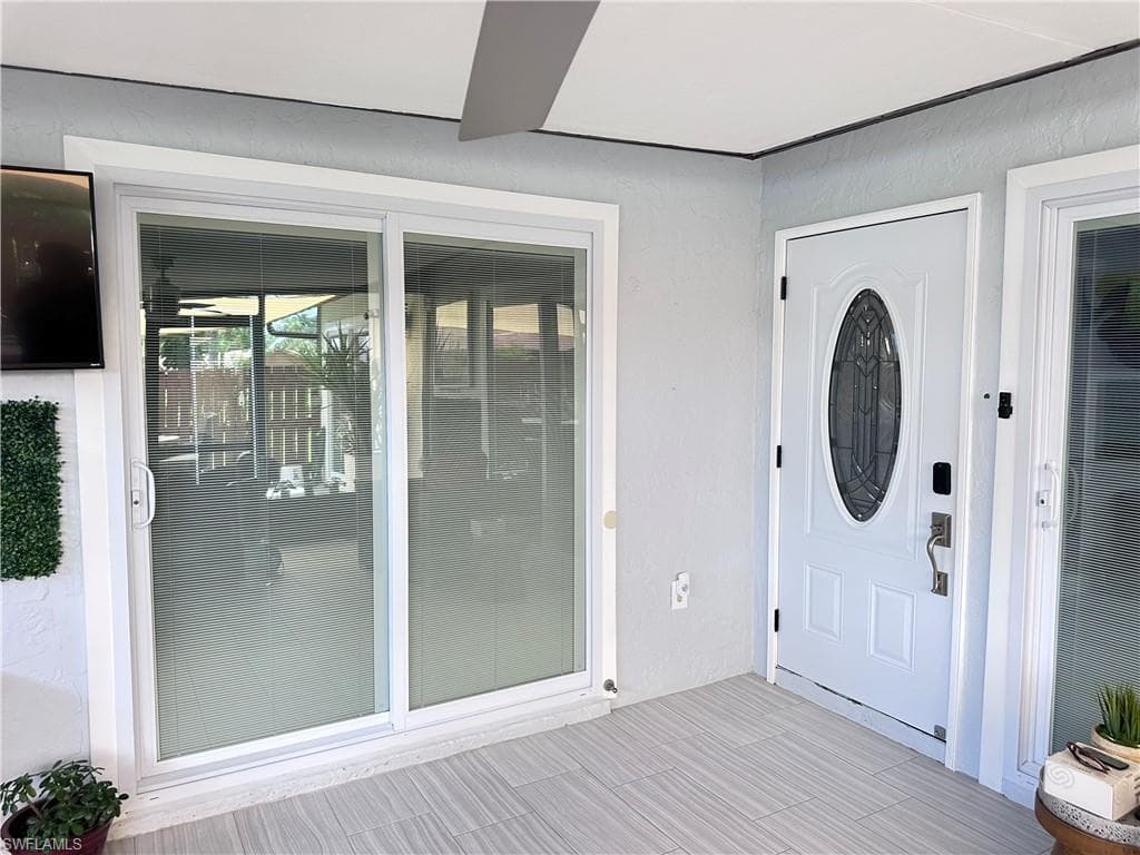 Entrance to property with stucco siding