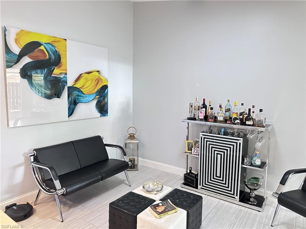 Living area with baseboards and wood finished floors