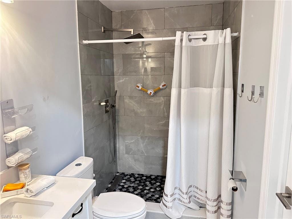 Bathroom featuring a shower stall and vanity