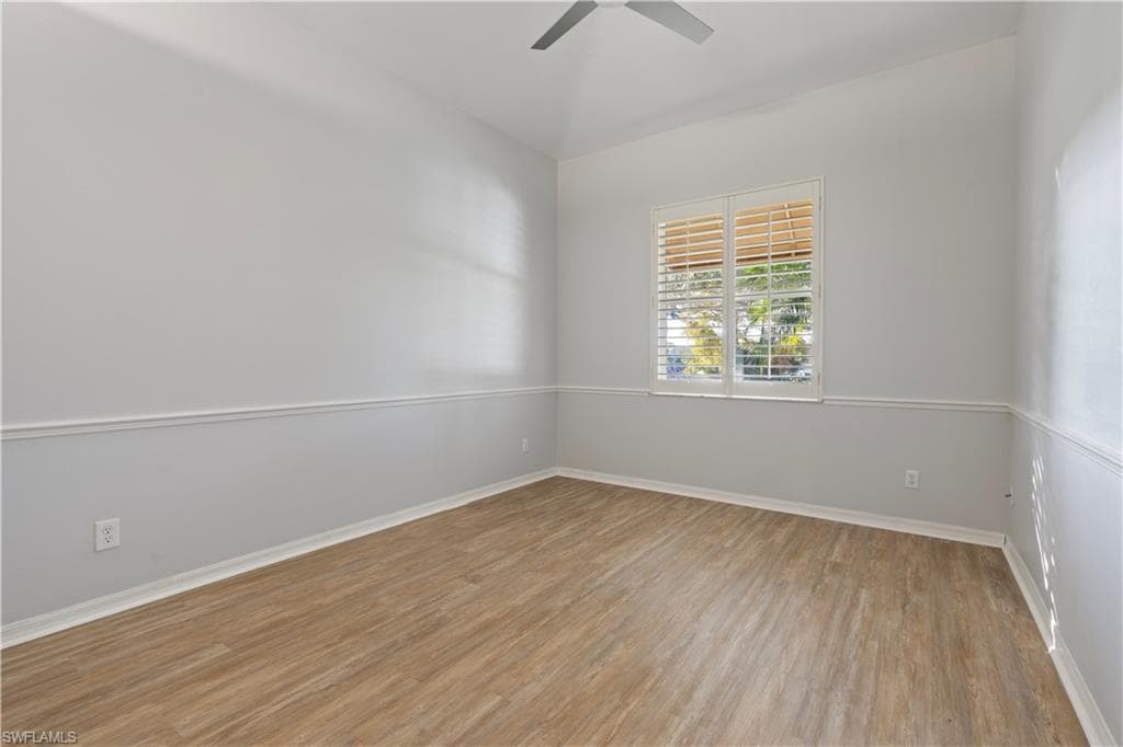 Unfurnished room featuring light wood-type flooring and ceiling fan