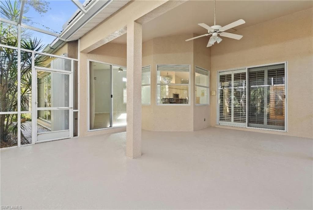 View of patio / terrace with a ceiling fan, a sunroom, and glass enclosure