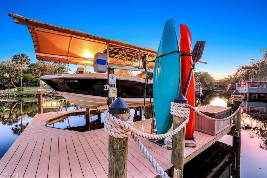 Dock area featuring 7,000 lb. boat lift and a water view