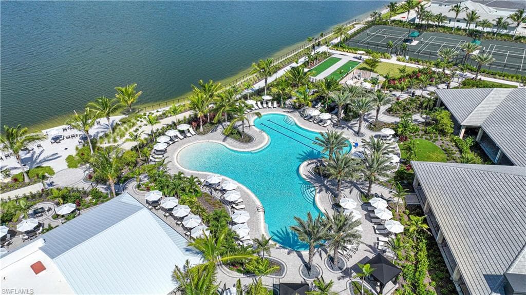 Aerial view of a pool and a nearby body of water