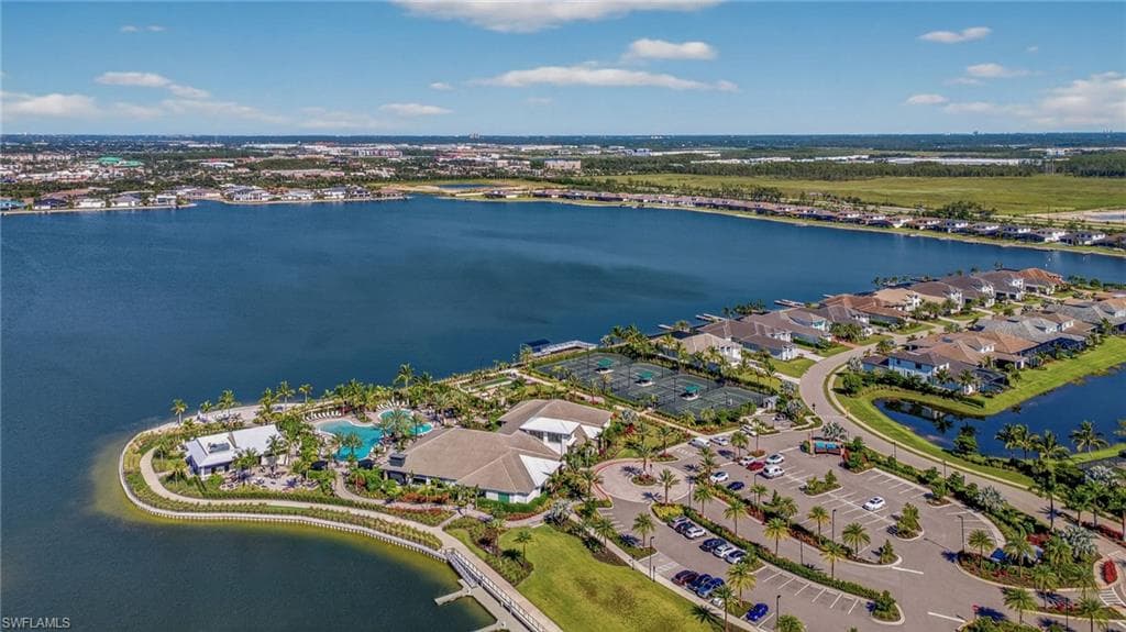 Aerial view of property's location with a large body of water and nearby suburban area