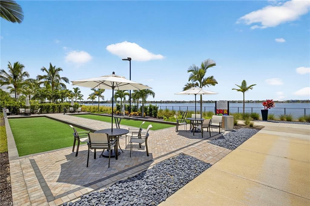 View of patio / terrace with a water view and a game area
