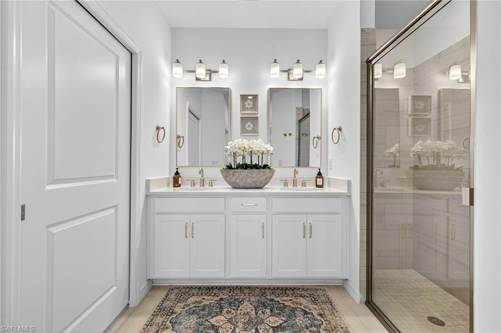 Full bathroom with a shower stall and double vanity