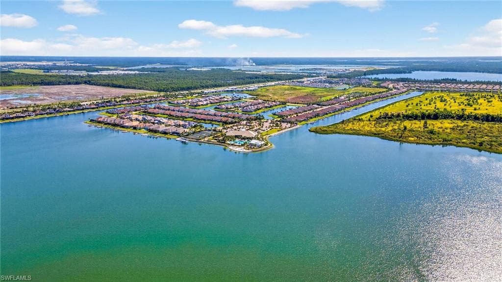Aerial perspective of suburban area featuring a large body of water