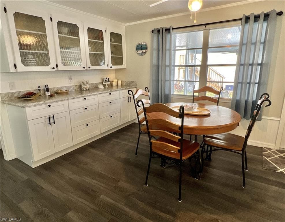 Dining space with built in buffet, dark wood-style vinyl flooring