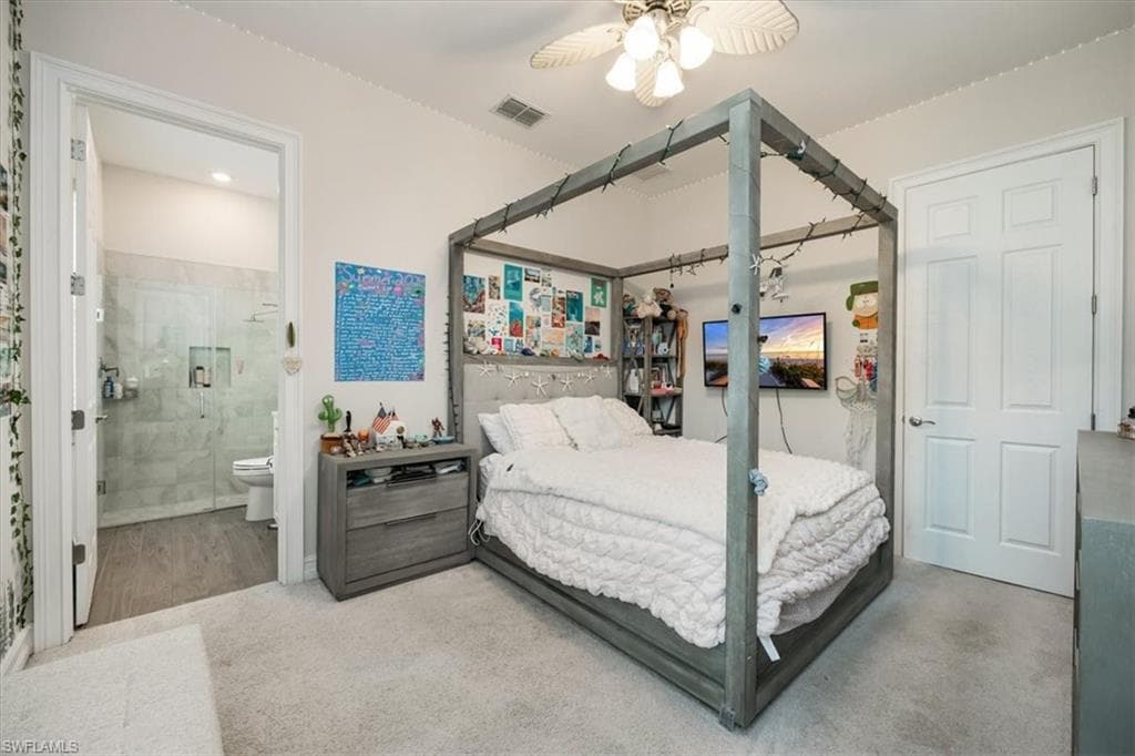 Carpeted bedroom with a ceiling fan